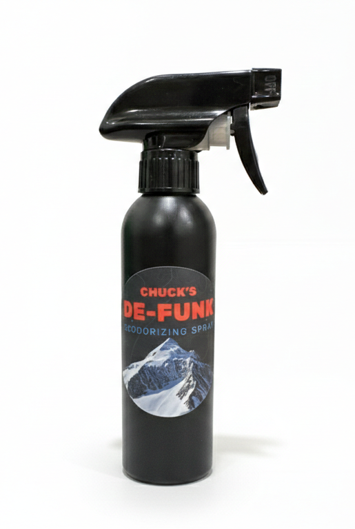 Black spray bottle with a label on a gray background