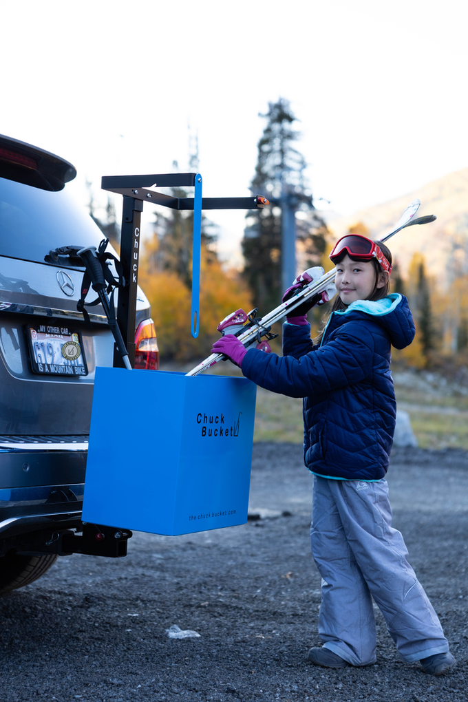 young-girl-loading-trailer-hitch-ski-rack