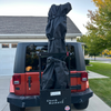Red Jeep with a ski cargo hitch rack, chuck bucket, attached. With a Ski cover holding the skis. 