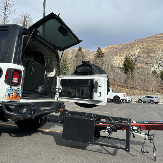 Picture of Chuck bucket fully tilted with a jeep swing door open. 