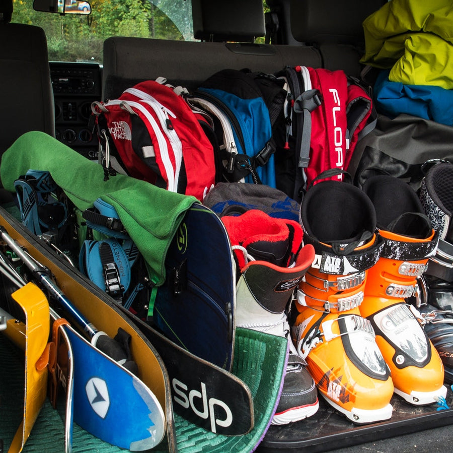 Vehicle cargo area packed with ski gear